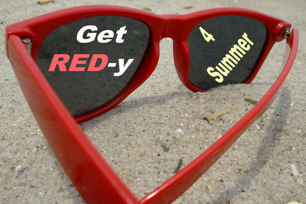 Red sunglasses on sand